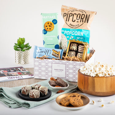 Petite & Perfect gift box featuring sea salt popcorn, chocolate chip cookies, more treats, and a black mug. Ideal to show employee appreciation.